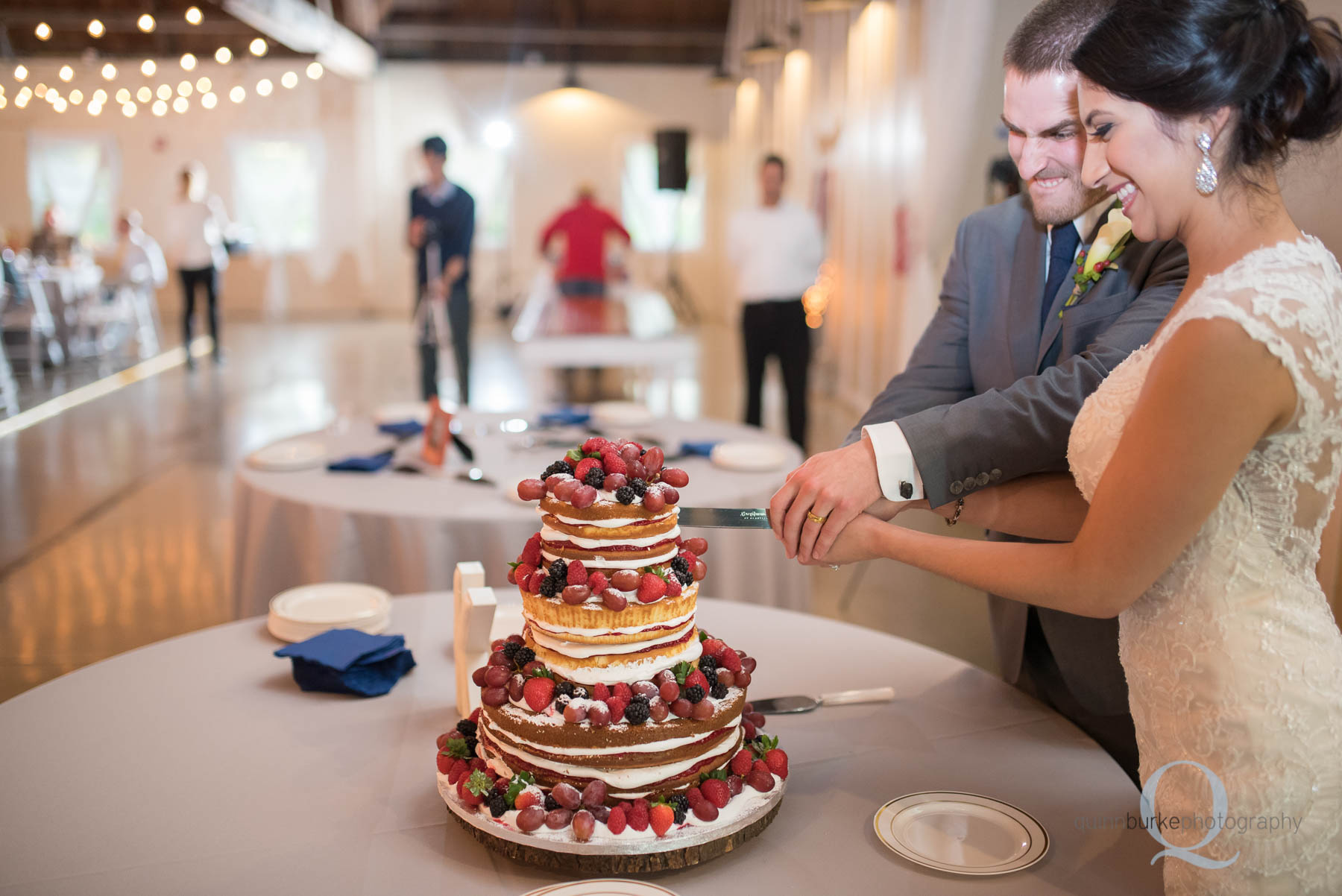 cutting wedding cake at Green Villa Barn 