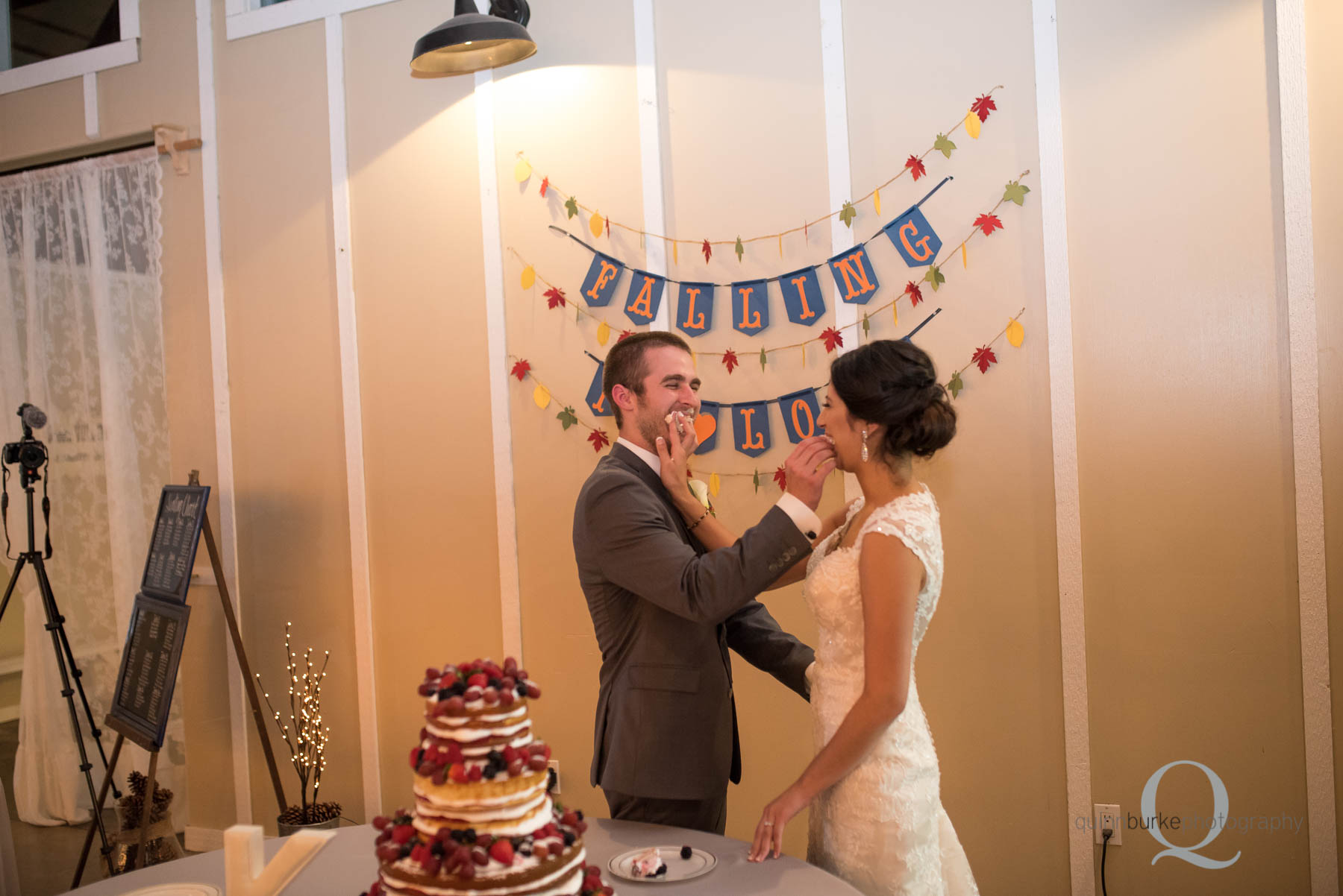 bride and groom feed cake Green Villa Barn wedding